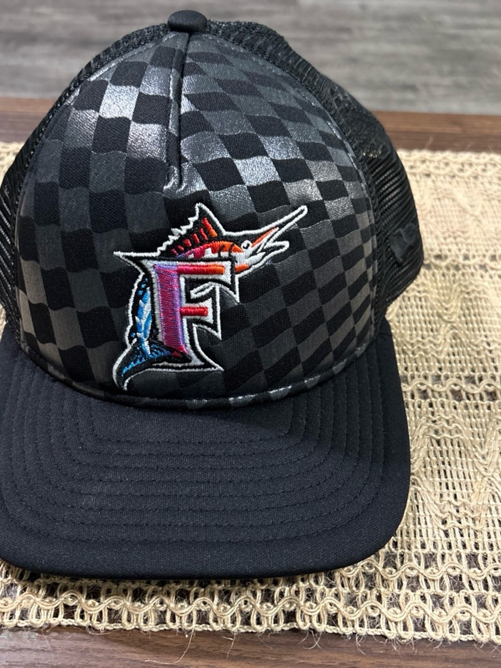 New Era Black Checkerboard Trucker Hat with Multicolor Marlin F Patch